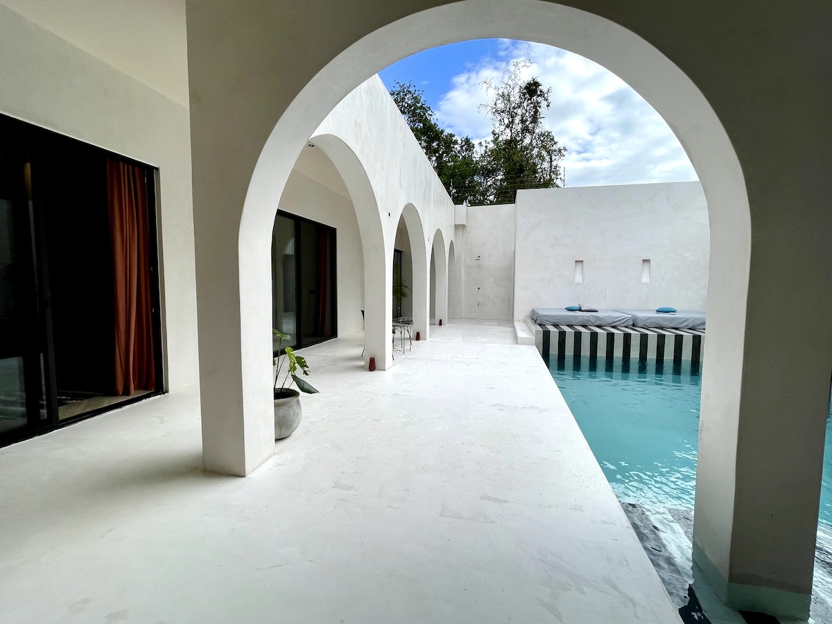 Casa Bali luxury swimming pool area with tropical garden and minimalist architecture