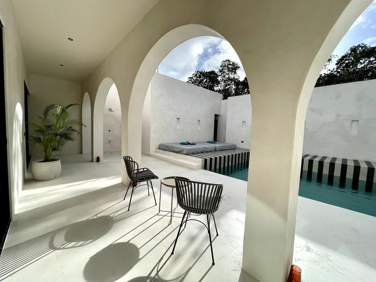 Casa Bali spacious king-size bedroom with minimalist decor and jungle views in Tulum rental villa